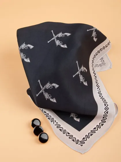 A creative fold of the crossed-pistols pocket square, styled with black buttons for a cohesive look.