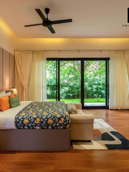 A spacious and serene master bedroom with direct access to the garden. The room includes a comfortable bed, a dedicated work-from-home corner, and soft, ambient lighting for a relaxing atmosphere.