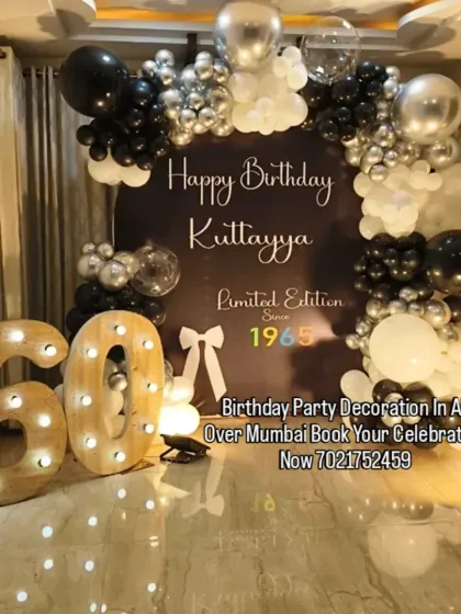 A sophisticated black, white, and silver theme for a 60th birthday. The custom backdrop, balloon arch, and large marquee numbers create a classy and memorable "Limited Edition" look.
