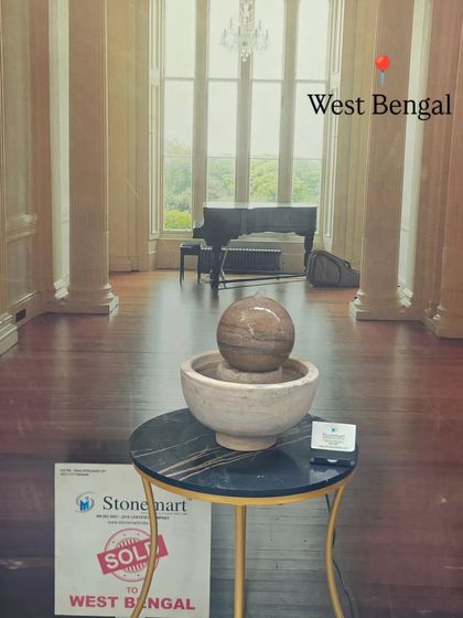 The tabletop fountain is shown in a grand room, illustrating that even a small piece can add a touch of elegance to a large space.