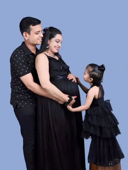 Classic and timeless. This family portrait features our simple black maternity gown paired with a matching black tiered dress for the daughter, creating a chic and coordinated look.