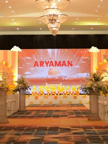 This wide-angle view shows the complete setup for the naming ceremony, including the grand stage, the guest seating arrangement with floral pillars, and the colorful runway, all designed to create a cohesive and impressive event.