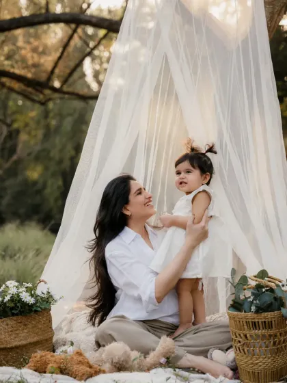 A mother holds her daughter during their outdoor teepee photoshoot. The connection between them is so clear and lovely.