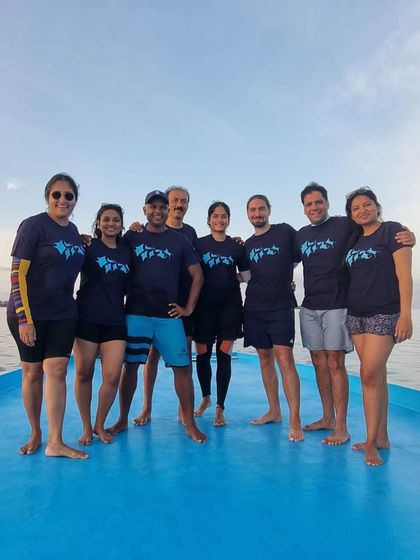 Our dive group in Hanifaru, Maldives, proudly sporting our custom trip tees. It's all about that team spirit.