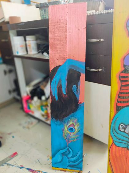 An older painting on wood depicting a Krishna-like figure. This piece is part of my studio sale.