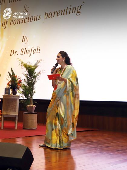 An organizer speaks on stage at the Conscious Parenting event. We believe in creating large-scale community events that bring parents and educators together for shared learning and inspiration.