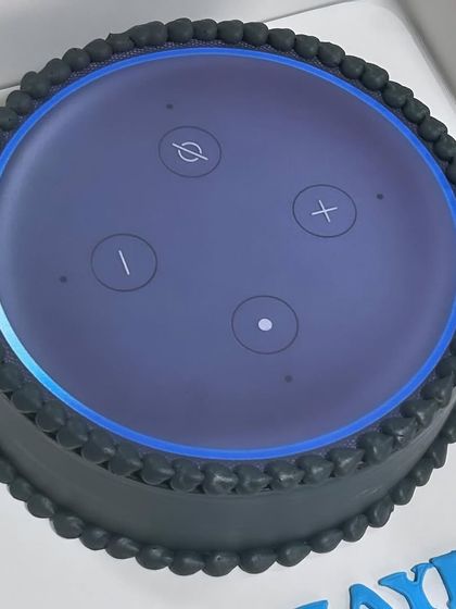 Another view of the incredibly realistic Amazon Alexa cake, showing the sleek black design.