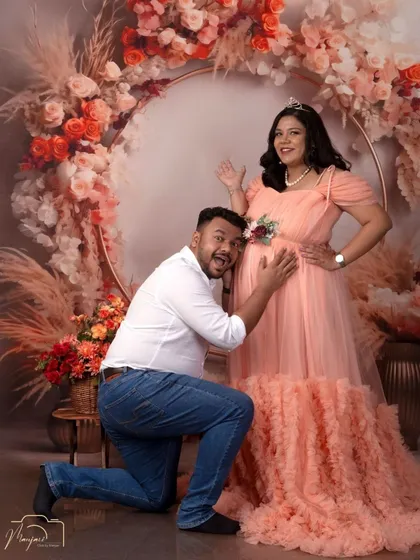 A fun and joyful shot! The dad-to-be's excited expression as he listens to the bump is priceless and adds a touch of humor to the session.