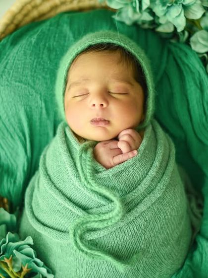 Another variation of the green theme, this time with the baby's hand peeking out, adding a touch of personality to the pose.