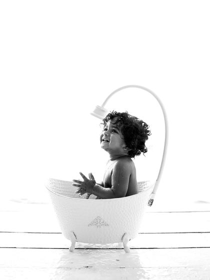 A joyful black and white shot from a bath session. Without color, you can really focus on his happy expression and the fun splashy movement.