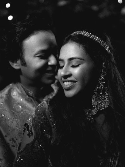 A timeless black and white portrait of the couple, capturing a quiet, intimate moment amidst the Sangeet festivities.