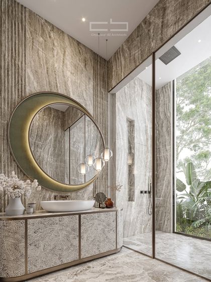 This bath space balances nature’s serenity with architectural precision. A refined material palette, organic forms like the crescent-shaped mirror, and ambient lighting make every moment a retreat.