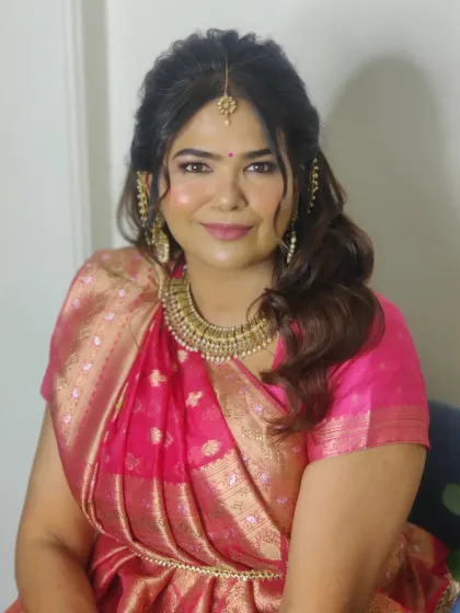 My client Swati in a traditional Gujarati drape for her second look of the day. The vibrant pink saree is paired with soft, shimmery makeup.