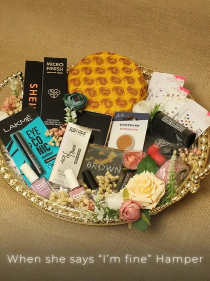 The "When she says 'I'm fine'" hamper. A playful and thoughtful gift idea, this tray is packed with a variety of makeup essentials to surely bring a smile to her face.