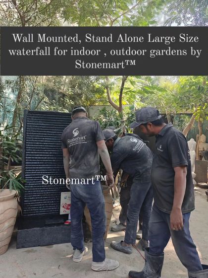 My team is shown moving the large, wall-mounted granite waterfall. This piece is heavy and built to last for generations.