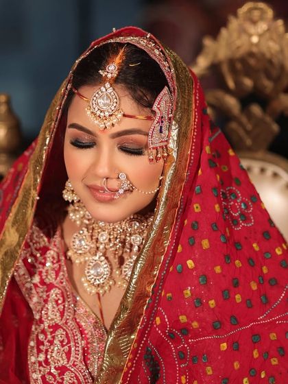 A beautiful Rajasthani-inspired bridal look. The Bandhani dupatta and traditional jewelry are complemented by a soft, glowing makeup look that is both regal and timeless.