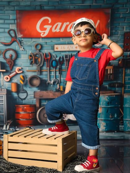 A little mechanic with a big personality. This garage-themed shoot with tools and a cool backdrop is perfect for a boy with a lot of attitude.