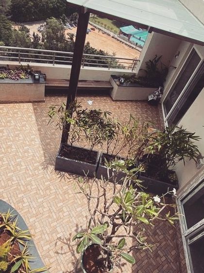 An aerial view of a terrace makeover at Klassik Landmark. This shows the layout of planters, a seating bench, and a small pergola, demonstrating how we thoughtfully arrange elements to create a functional and aesthetically pleasing space.