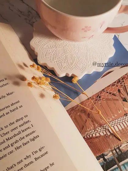 A quiet moment with a book and a cup of tea, resting on our white Mandala coaster. It’s these small rituals that our decor is made for.