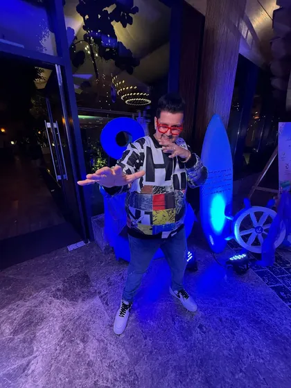 Striking a pose in the blue-lit entrance. It's all about bringing that signature DJ Alex flair to every space.