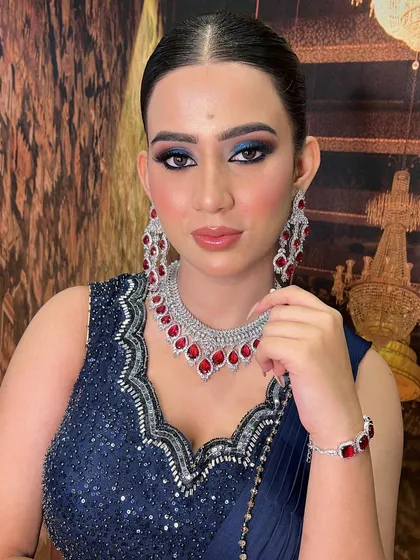 No whitewash, just gorgeous Indian skin. This engagement look features a dramatic blue smokey eye that beautifully complements her navy blue and ruby diamond outfit.