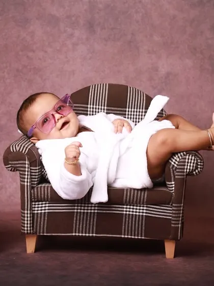 Kicking back and relaxing. This shot captures the pure confidence and charm of a six-month-old, perfectly at ease in the miniature lounge setup I created for this milestone session.
