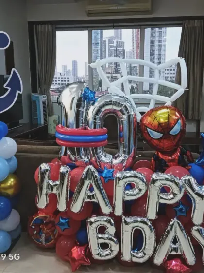 A compact and fun balloon arrangement for a 10th birthday, combining a nautical anchor with a Spider-Man theme.