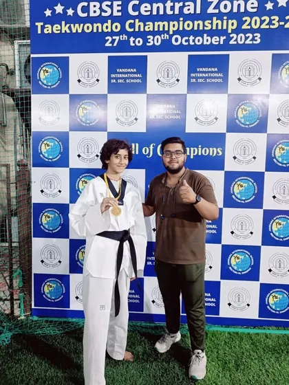 Roshni Tank proudly displays her gold medal from the CBSE Central Zone Championship. Her victory in the U-49kg category was a highlight for our team.