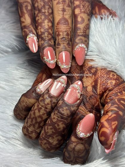 This bride wanted a glamorous look, so we adorned her peachy-pink nails with beautiful pearl and rhinestone borders that sparkle from every angle.