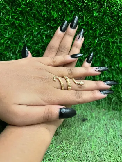 This manicure is all about sharp, dramatic style. The extra-long stiletto nails are painted in a glossy, opaque black for a fierce and confident statement.