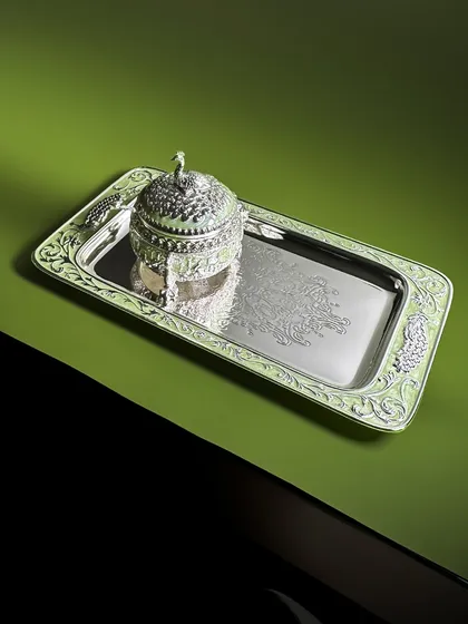 A regal composition against a dramatic green backdrop. Our intricately crafted enamel tray and peacock dry fruit box are designed to complement each other, creating a luxurious serving set.