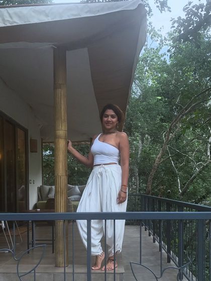 Standing on the balcony of our retreat accommodation, surrounded by lush greenery. I choose places that allow you to feel completely immersed in nature, where you can breathe fresh air and find peace.