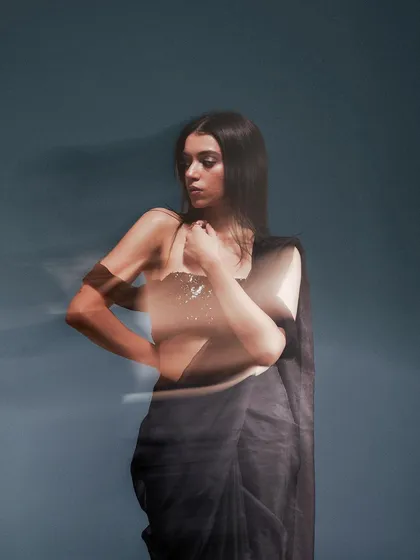 Another take on the motion blur effect, this shot captures a different angle and pose. The technique highlights the model's form while creating an artistic and abstract visual.
