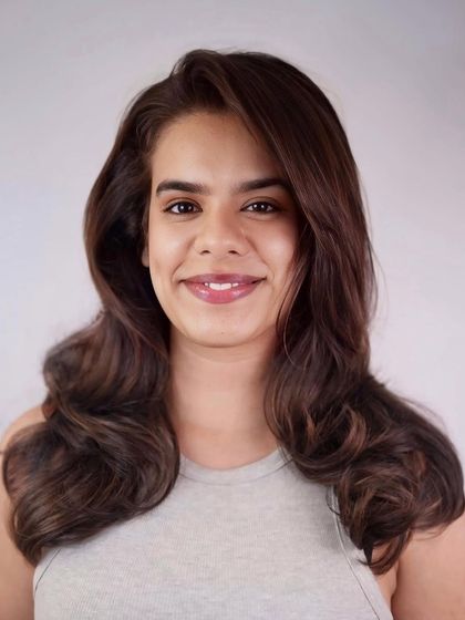 Soft waves dipped in color magic. This look features a subtle balayage on a dark base for a touch of dimension and shine.