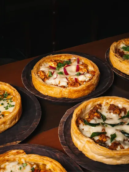 A close-up of our Puffizzas, showcasing the rich toppings and golden, flaky crust. Each one is a trip down memory lane.