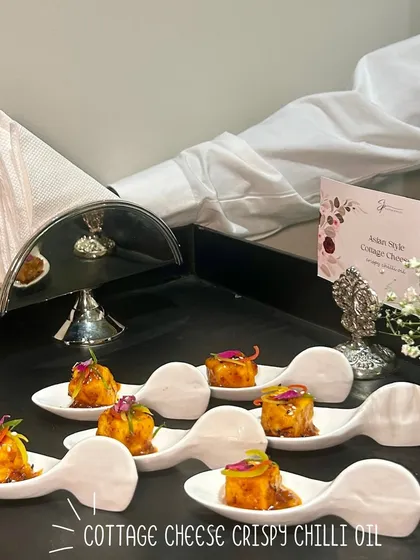 Cottage Cheese in Crispy Chilli Oil, served on unique spoon-shaped plates for a modern and stylish presentation.