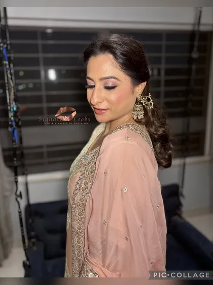 A side profile showing the flow of the curls and the elegant hair accessory. This is a timeless look for any wedding guest.