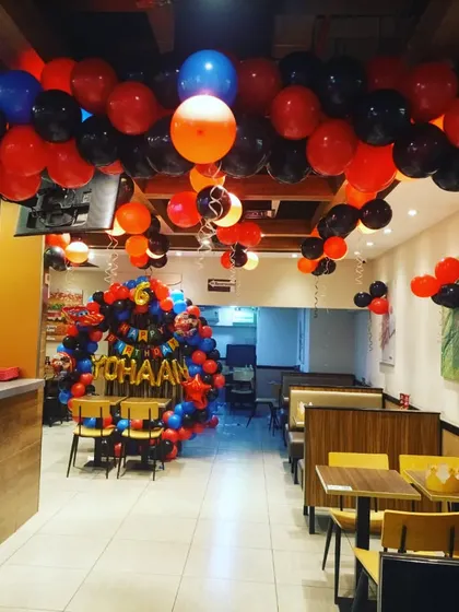 A full view of the restaurant decorated for a racing cars theme. I can transform any space, with balloon arches and ceiling decorations to create a festive environment.