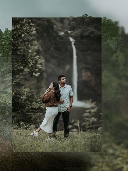 A stunning wide-angle shot of a couple standing before a majestic waterfall, emphasizing the beauty of nature in their love story.