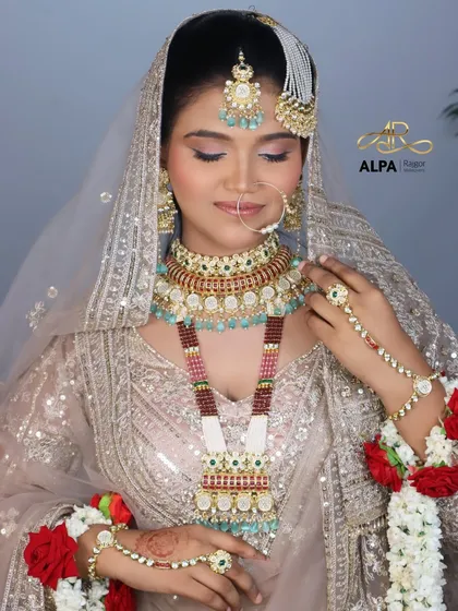The full ensemble, showing the heavily embroidered outfit paired with a soft, dewy makeup base and a neutral lip color.