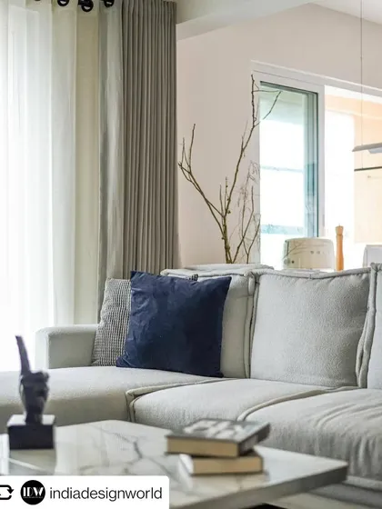 The comfortable and stylish living room sofa, featured in India Design World. The use of boucle fabric and a neutral palette creates a warm and inviting atmosphere.