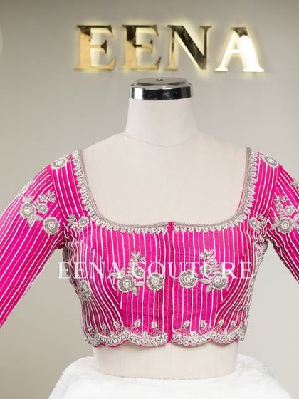 Pretty in pink, this raw silk blouse features intricate pearl and silver thread work in a striped pattern. I added floral motifs and delicate danglers on the sleeves for a touch of playful elegance.