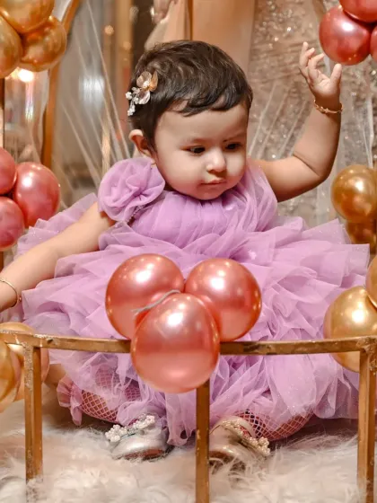 The little wave says it all. These are the candid, unposed moments that truly capture the personality of your child during their milestone celebration.