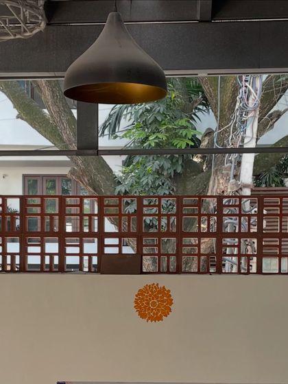 A detail of the studio's decor, with a modern pendant lamp and a traditional mandala motif on the wall. It reflects our blend of contemporary design and heritage craft.