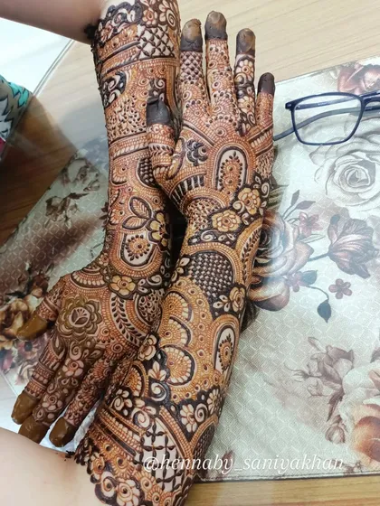 A non bridal design with a creative pose, showing the full length of the intricate patterns.