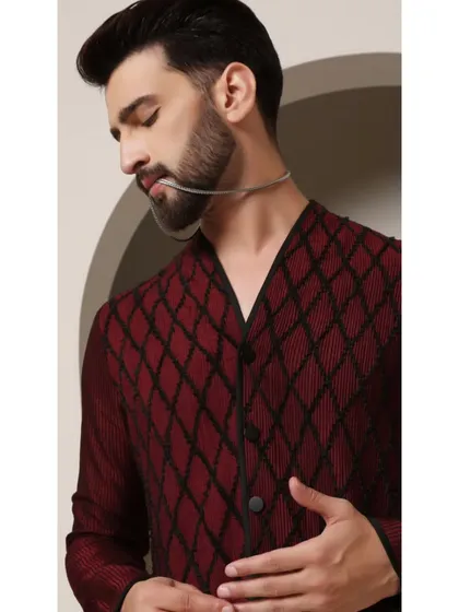 A close-up of the 'Maroon Regalia' kurta, focusing on the rich maroon fabric and the intricate diamond pattern that defines this contemporary piece.