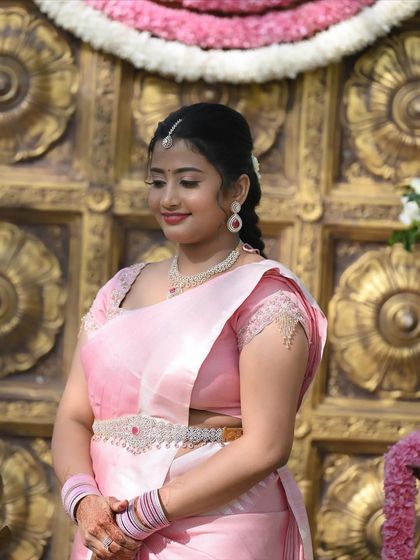 This image highlights the details of the look, from the neat hairstyle to the perfectly draped saree and subtle makeup.