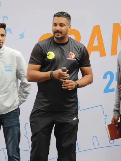 Our coach speaking on stage during a community event. We use these opportunities to share insights on fitness, sports, and the importance of an active lifestyle.