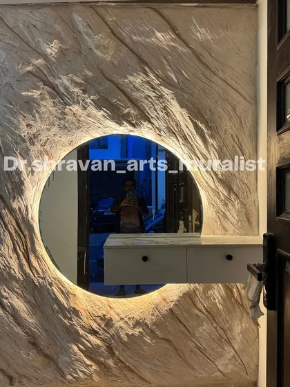 Art can be functional too. Here, I sculpted a raw, organic rock texture around a circular mirror, integrating backlighting to make it a stunning foyer feature. It’s the first thing you see when you enter, setting a tone of natural elegance.