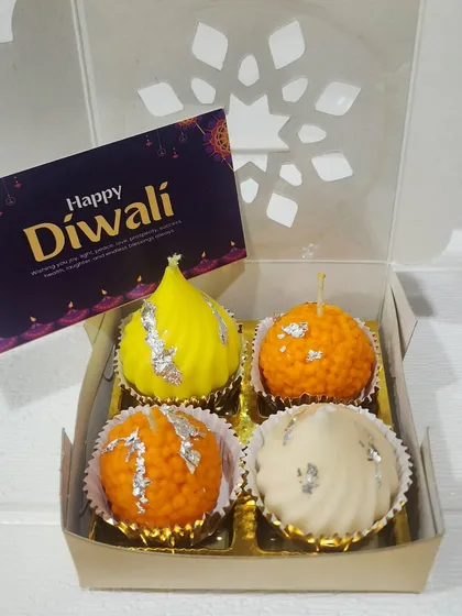 These are my sweet Mithai Candles, a truly unique gift for Diwali. This set includes candles shaped like a modak, motichoor ladoo, and peda, all beautifully packaged and ready to light up the festive season.